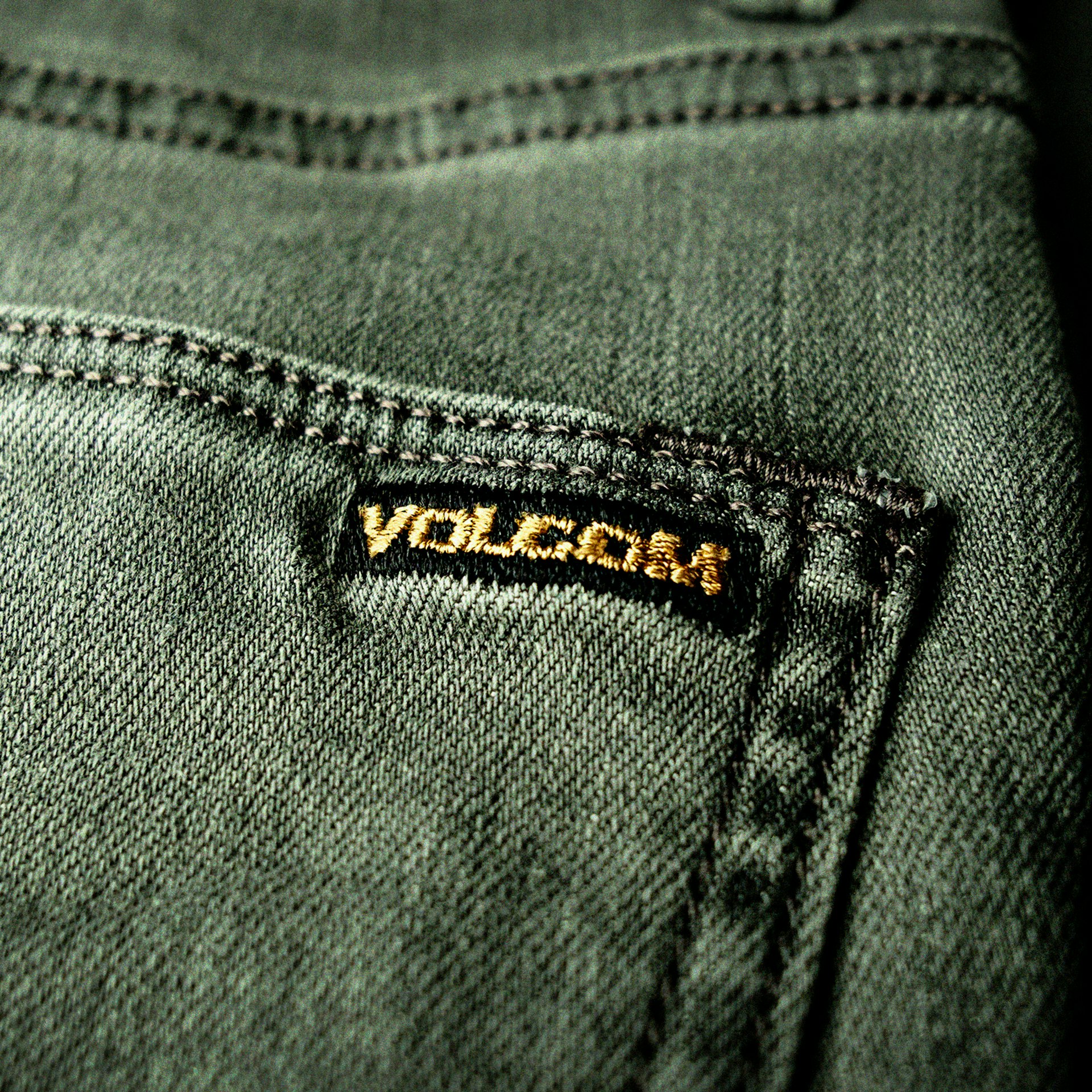 a close up of a pair of jeans with the word vulcan on it
